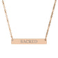 Rose gold bar necklace with engraved uppercase text "SACRED" on a sleek matte pendant, suspended on a delicate matching rose gold chain. Minimalist spiritual affirmation jewelry for sacred energy and divine connection.
