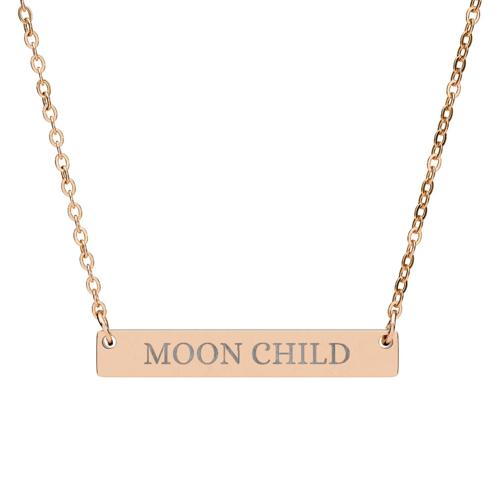 Rose gold bar necklace with engraved uppercase text "MOON CHILD" on a sleek matte pendant, suspended on a delicate matching rose gold chain. Minimalist spiritual affirmation jewelry for lunar energy, intuition, and cosmic connection.