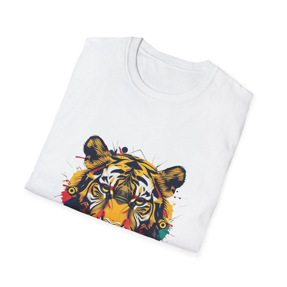 White folded unisex cotton t-shirt featuring bold Year of the Tiger graphic print: vibrant abstract tiger face portrait with fierce intense eyes, detailed stripes, large ears, and dynamic multicolored paint splatters in yellow, orange, red, blue, black, and teal tones exploding outward. Chinese text "虎年" (Year of the Tiger) printed below in black. Zodiac Chinese New Year motivational crewneck tee.