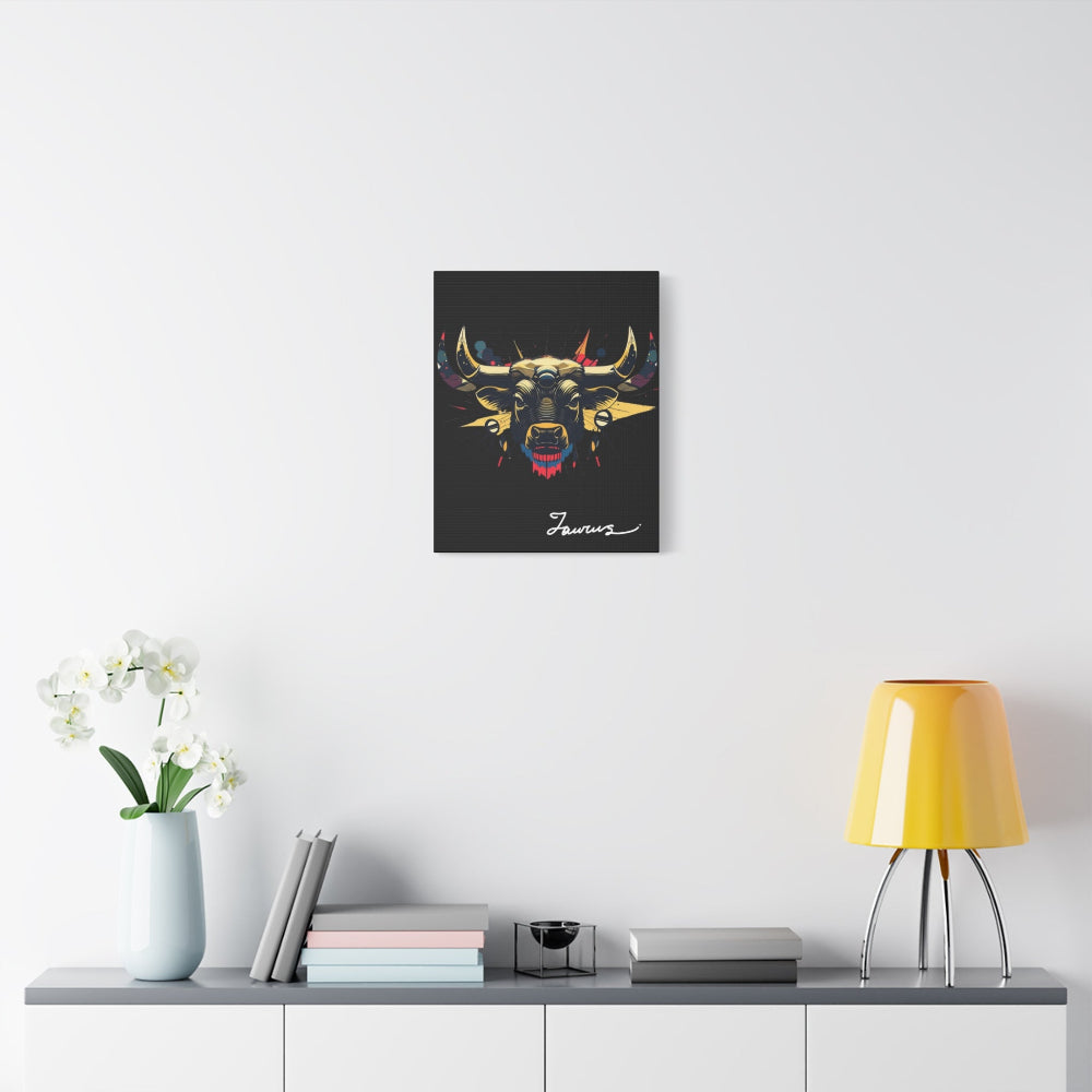 Black canvas wall art print of colorful abstract Taurus bull head with large curved horns, intense expression, geometric patterns, and cosmic splatters on dark background, featuring "Taurus" in elegant white cursive displayed in a modern home décor setting above a console table with books and yellow lamp.