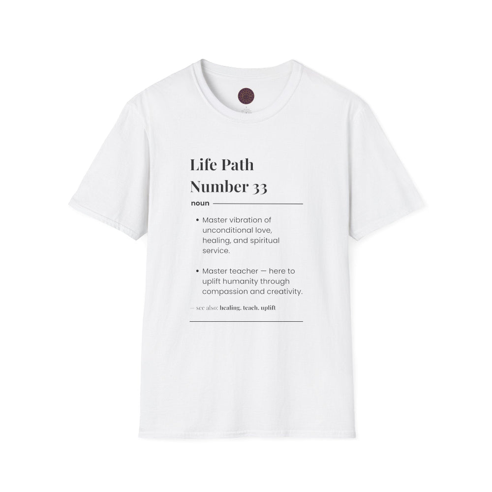 White unisex cotton t-shirt laid out flat featuring bold Life Path Number 33 numerology print in dictionary style: exact text reading "Life Path Number 33 noun · Master vibration of unconditional love, healing, and spiritual service. · Master teacher — here to uplift humanity through compassion, kindness, and creativity. – see also: healing, teach, uplift". Motivational spiritual numerology crewneck tee flat lay with visible purple/gold zodiac wheel inner tag.