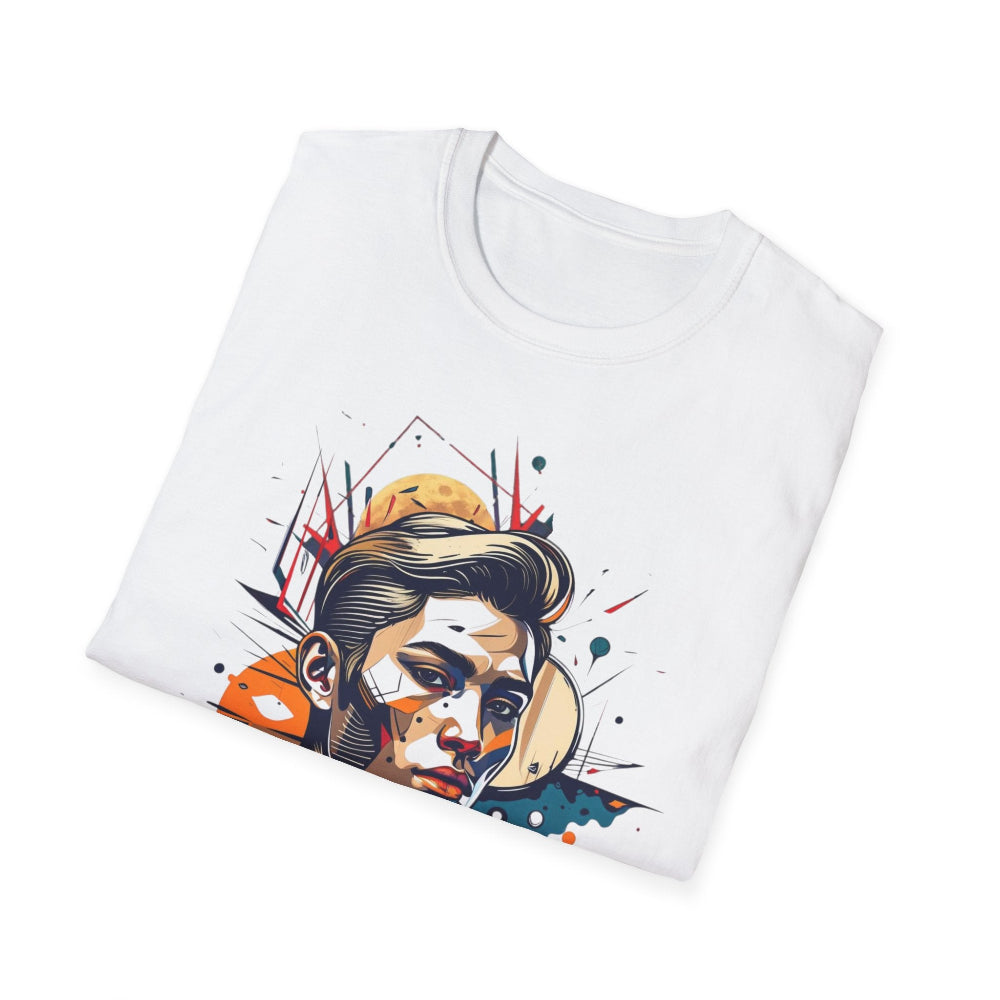 White folded unisex cotton t-shirt featuring bold Primal graphic print: stylized intense clean-shaven man portrait with short slicked-back hair, vibrant multicolored geometric face in orange, teal, red, yellow and blue tones, dynamic paint splatters and abstract shards exploding outward, moon accent detail. Primal masculine energy motivational crewneck tee.