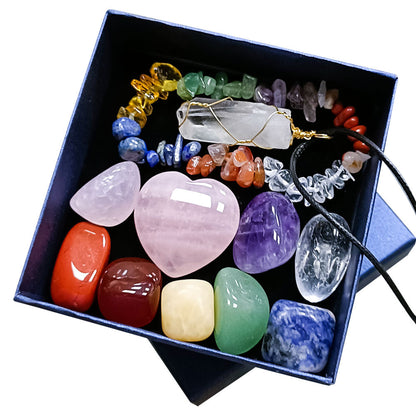 Chakra healing crystal gift set in blue gift box – includes rose quartz heart, tumbled gemstones (jasper, carnelian, citrine, aventurine, lapis, amethyst, quartz), wire-wrapped clear quartz pendant on cord, and chakra chip bracelet, premium spiritual wellness collection