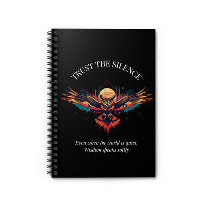 Close up of notebook with a colorful abstract owl with intense eyes, moon accents, geometric details, and paint splatters on a black background, featuring the words "TRUST THE SILENCE" and quote "Even when the world is quiet, wisdom speaks softly".