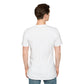 White unisex cotton crewneck t-shirt back view on male model with short brown hair: plain blank white with no print, short sleeves, relaxed fit, and clean hem. Soft comfortable premium basic white t-shirt rear view.