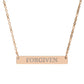 Rose gold bar necklace with engraved uppercase text "FORGIVEN" on a sleek matte pendant, suspended on a delicate matching rose gold chain. Minimalist motivational affirmation jewelry for forgiveness, healing, and emotional release.