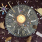 Lit candle placed in the center of a black and gold Wheel of the Year divination board, surrounded by clear quartz points, tumbled crystals, pinecones, and a crystal wand on a dark starry cloth. Mystical pagan altar setup for seasonal rituals and spiritual practice.