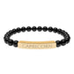 Black beaded bracelet featuring polished round black onyx or obsidian beads with a gold-plated curved bar engraved "CAPRICORN" in uppercase letters. Stretch-fit zodiac-inspired jewelry for grounding,