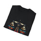 Black folded unisex cotton t-shirt featuring bold Libra zodiac graphic print: vibrant abstract scales of justice with balanced arms, intricate geometric triangular motifs, central axis design, symmetrical layout, and dynamic multicolored paint splatters in gold, red, navy, teal, and black tones bursting outward. Elegant white cursive "Libra" text below. Astrology zodiac motivational crewneck tee.
