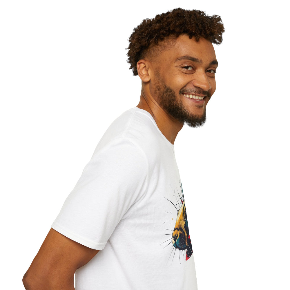 White unisex cotton t-shirt in side profile on smiling male model with curly hair and beard, featuring bold Year of the Tiger graphic on chest: vibrant abstract tiger face portrait with fierce intense eyes, detailed stripes, large ears, and dynamic multicolored paint splatters in yellow, orange, red, blue, and black tones exploding outward. Chinese text "虎年" (Year of the Tiger) printed below in black. Zodiac Chinese New Year motivational crewneck tee.