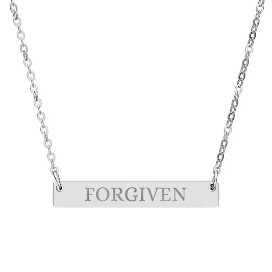 Silver bar necklace with engraved uppercase text "FORGIVEN" on a sleek matte pendant, suspended on a delicate matching silver chain. Minimalist motivational affirmation jewelry for forgiveness, healing, and emotional release.