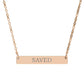 Rose gold bar necklace with engraved uppercase text "SAVED" on a sleek matte pendant, suspended on a delicate matching rose gold chain. Minimalist motivational affirmation jewelry for grace, redemption, and spiritual protection.