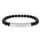 Bracelet with polished black onyx beads and silver curved bar engraved "GEMINI" in uppercase letters. Stretch-fit zodiac-inspired crystal jewelry.