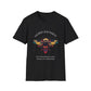 Black unisex cotton t-shirt laid out flat featuring bold "Sacred Alignment" graphic: vibrant abstract bee with detailed wings and body, colorful geometric accents, and dynamic paint splatters in red, orange, teal, blue, and gold tones bursting outward around an orange moon background. Arched white text "SACRED ALIGNMENT" above and smaller inspirational quote "Even when progress is quiet, the harvest is still forming" below. Motivational spiritual empowerment crewneck tee.