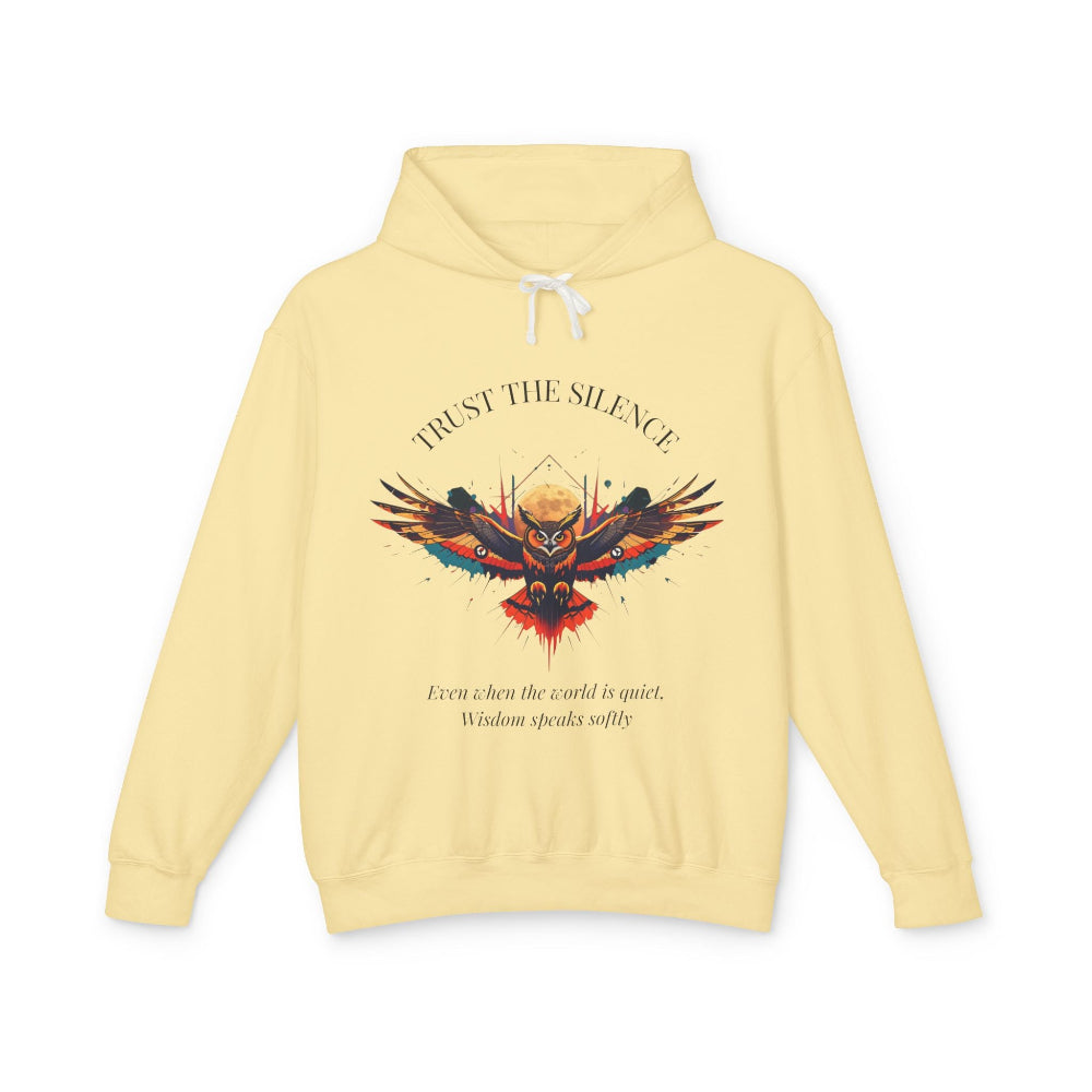 Light yellow hoodie with colorful owl graphic, "TRUST THE SILENCE" text and quote "Even when the world is quiet, wisdom speaks softly"